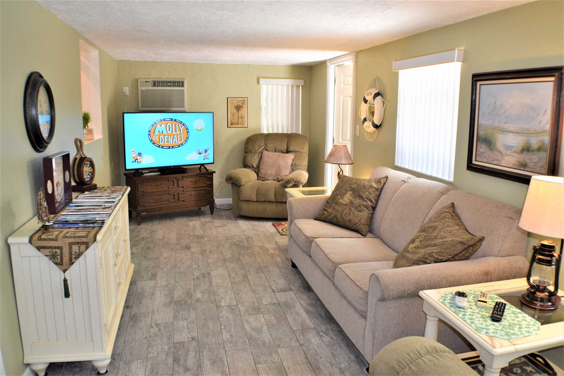 Florida room features HDTV and convertible sofabed.