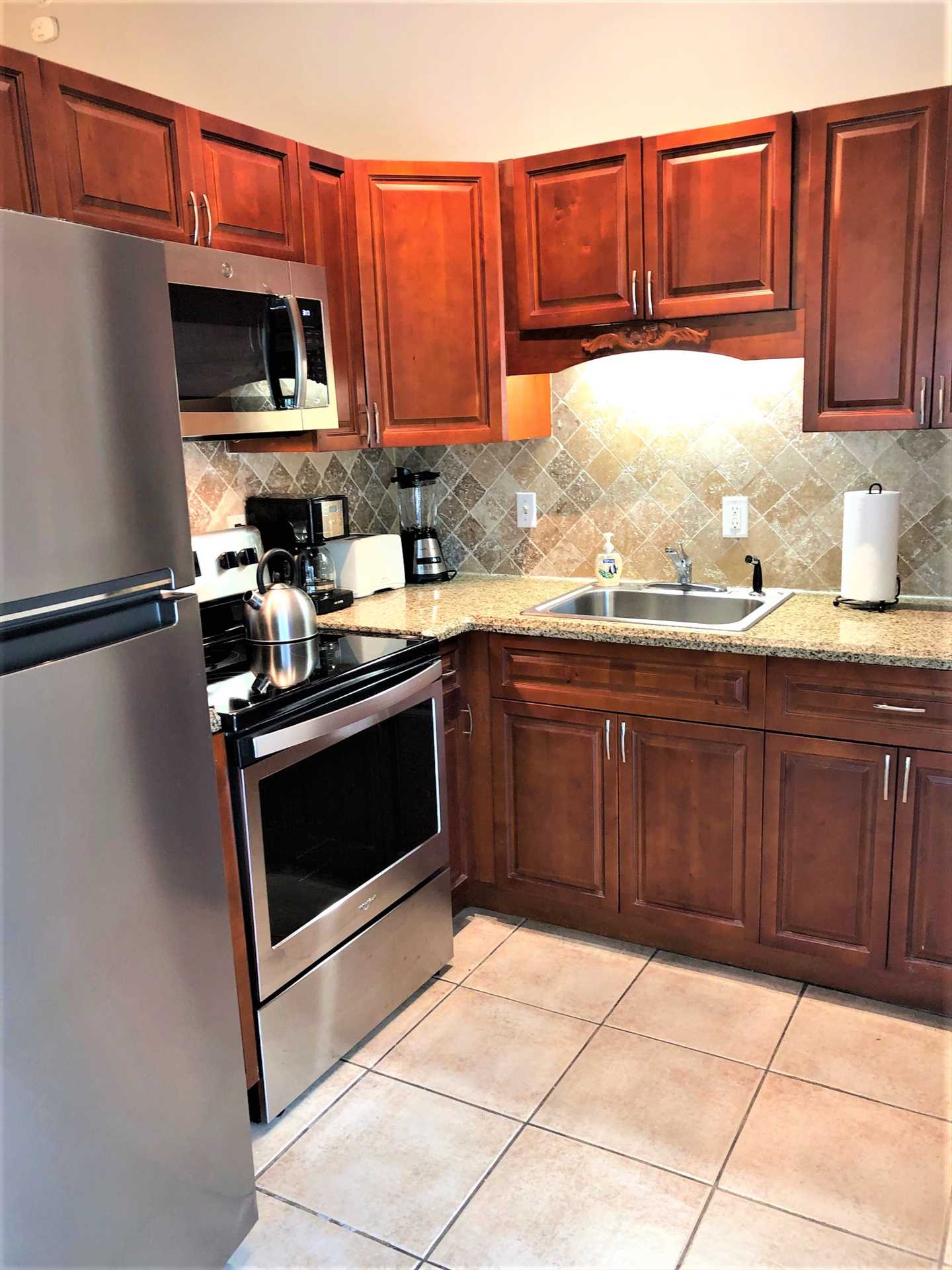 Galley kitchen has all new stainless appliances.