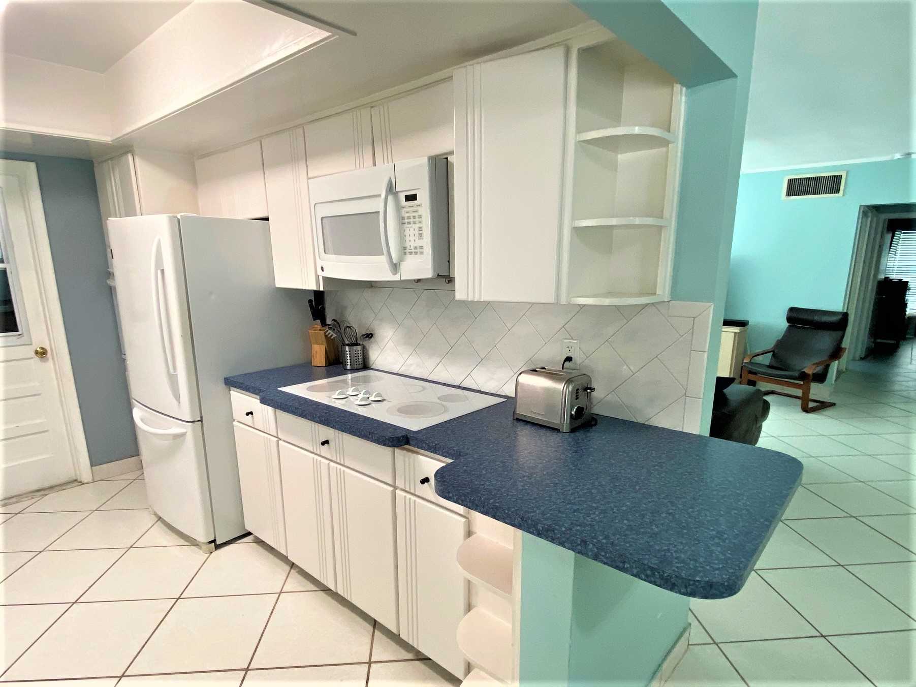 Kitchen has cooktop, microwave and conventional oven.