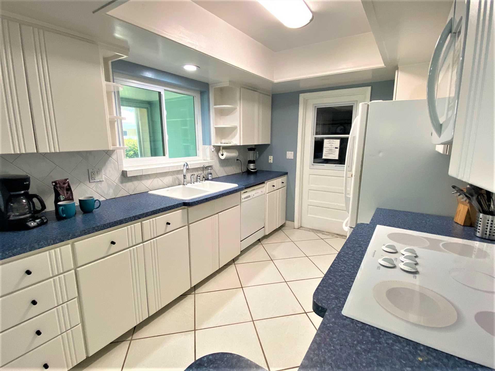 Fully equipped kitchen has all appliances, dishes, cookware 