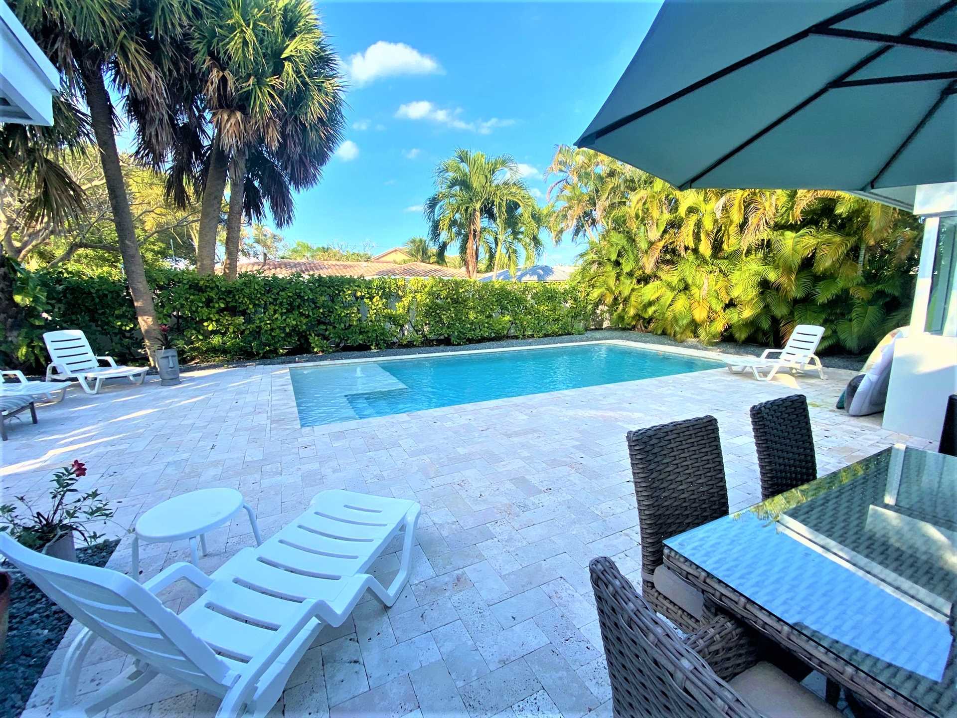 The pool deck is surrounded by a backyard six foot privacy f